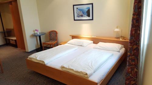 Postel nebo postele na pokoji v ubytování CenterCourt Hotel