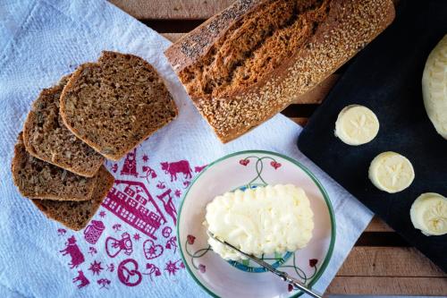 a plate of bread and butter on a table at Landhaus am Stein in Bad Wiessee