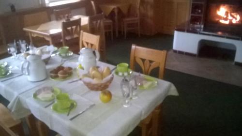 a table with a white table cloth with fruit on it at Pension Pek in Kubova Huť