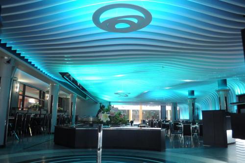 a blue ceiling in a restaurant with tables and chairs at Malligi,Hampi in Hospet