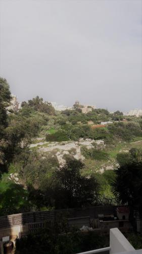 a view of a hill with trees and a field at Duplex Maisonette with Heated P-Pool and Jacuzzi in St Julian's