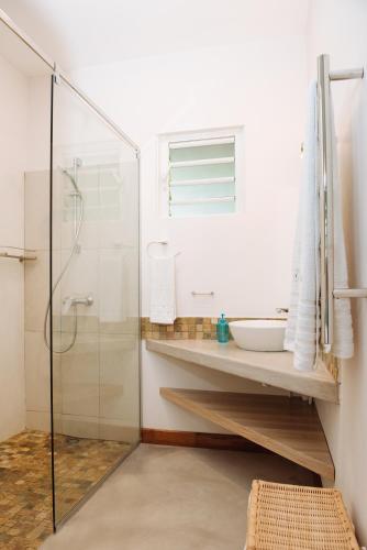 a bathroom with a sink and a shower at Coconuts in Grand Baie