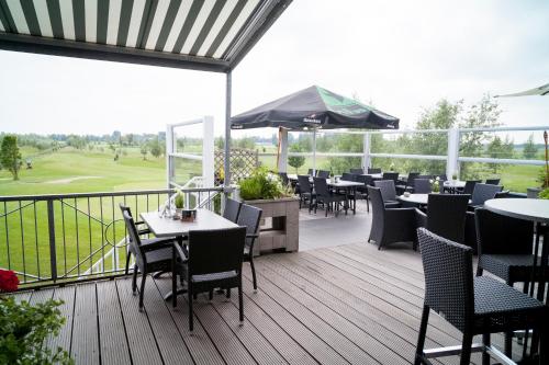 a restaurant with tables and chairs on a deck at Hotel Beemster in Middenbeemster