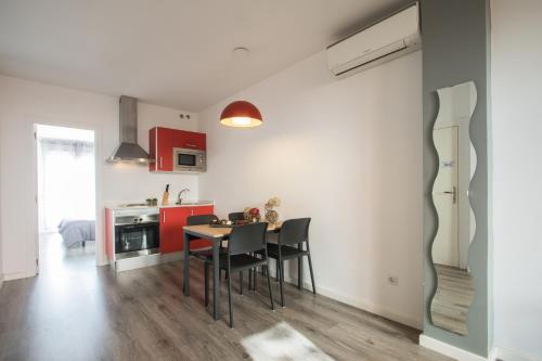 a kitchen with a table and chairs and a refrigerator at Flatsforyou Turia in Valencia