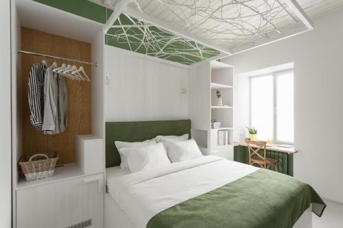 a bedroom with a large bed with a green headboard at City Hotel Bortoli by Ribas in Odesa