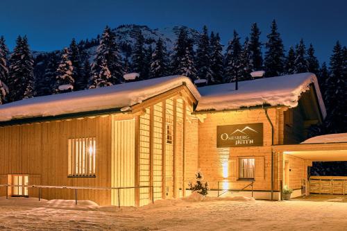 a building with a sign on it in the snow at Omesberg-Hütt'n in Lech am Arlberg