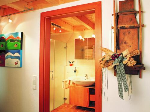 a bathroom with a sink and a mirror and a door at Ferienwohnung Anderl in Obertauern