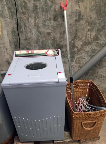 a washing machine with a basket next to it at N-square Hostel 任意宿背包客棧 in Yuanli