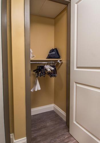 a closet in a hotel room with a door at Hotel Ithaca in Ithaca