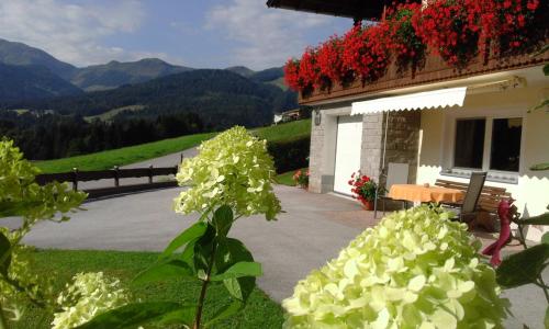 a house with flowers on the side of it at Appartement Schilcher in Oberau