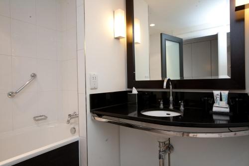 a bathroom with a sink and a mirror at Malmaison Birmingham in Birmingham