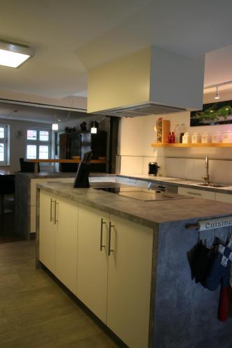 a kitchen with white cabinets and a counter top at Altstadthaus Dinkelsbühl in Dinkelsbühl