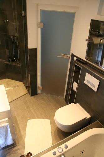 a bathroom with a toilet and a sink at Altstadthaus Dinkelsbühl in Dinkelsbühl