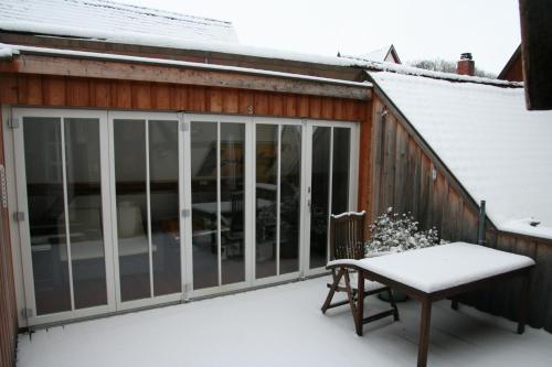 a sliding glass door on a house in the snow at Altstadthaus Dinkelsbühl in Dinkelsbühl