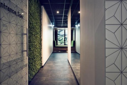 a hallway with plants on the walls of a building at WestCord Hotel Eindhoven in Eindhoven