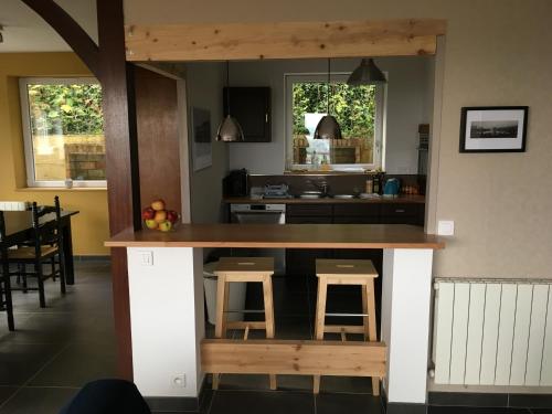 a kitchen with a counter with stools in it at VUE SEINE Chambre Panorama in La Bouille
