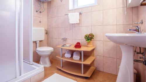 a bathroom with a toilet and a sink at Apartment Josephine 2 in Malinska