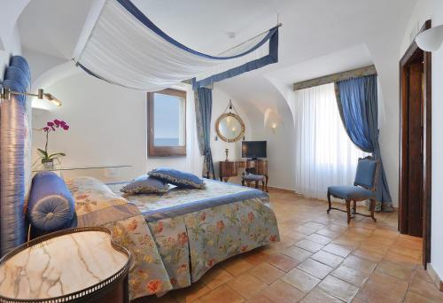 a bedroom with a bed and a table and chairs at San Francesco Resort in Agropoli