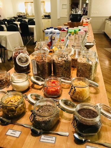 a table with many jars of food on it at Nynäsgården Hotell & Konferens in Nynäshamn
