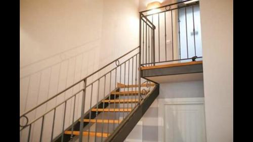 a spiral staircase in a building with a window at Agriturismo Casanova di Nardini in Scandicci