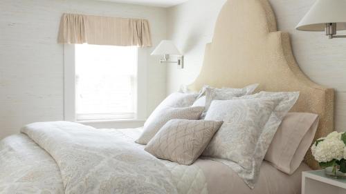a bedroom with a white bed with pillows at 33 Main in Lenox