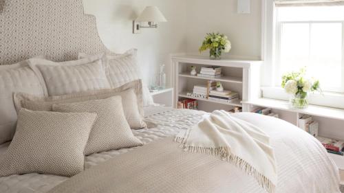a bedroom with a white bed with pillows and a window at 33 Main in Lenox