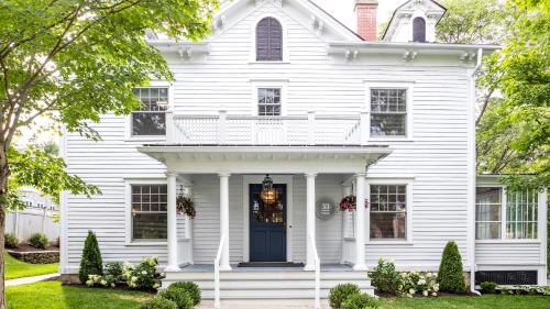 a white house with a blue door at 33 Main in Lenox