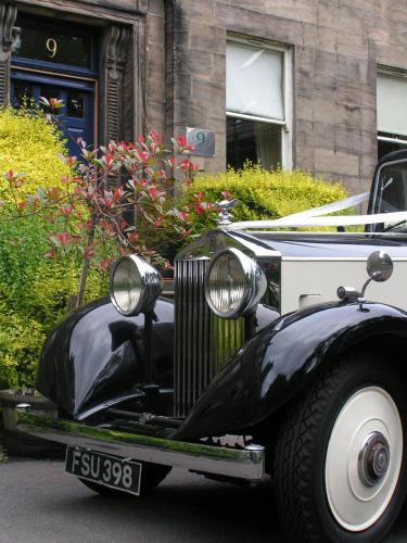an old black and white car parked on the street at Ashtree House Hotel, Glasgow Airport & Paisley in Paisley