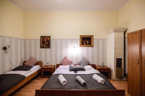 a bedroom with two beds with pillows on them at Golden Lion Guest Rooms Szewska 19 in Kraków