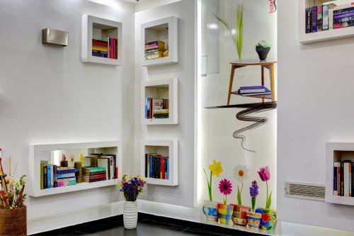 a wall with bookshelves and a shelf with books at Hotel Boutique 36 in Sarajevo