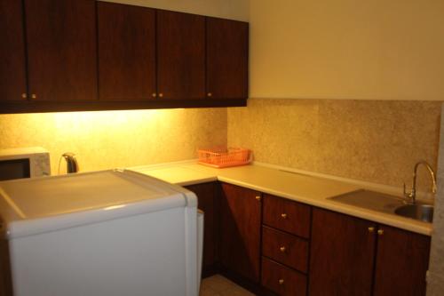 a kitchen with a sink and a counter top at FnF Suite @ Time Square in Kuala Lumpur