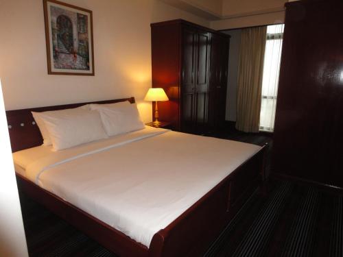 a bedroom with a large bed with a white mattress at FnF Suite @ Time Square in Kuala Lumpur