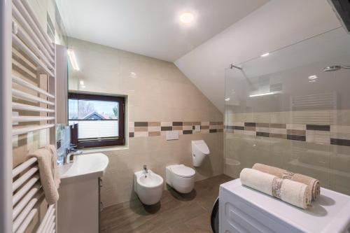 a bathroom with a sink and a toilet at Lake Bled Apartment Zerovec in Bled