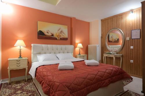 a bedroom with a large bed and a mirror at Xenonas Epavli in Levidhion