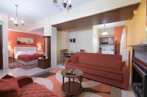 a living room with a red couch and a room with a bed at Xenonas Epavli in Levidhion