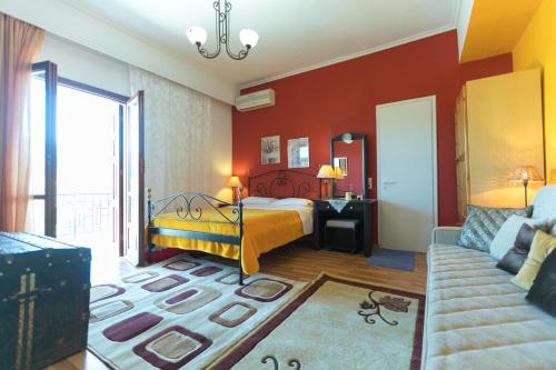 a bedroom with a bed and a couch at Xenonas Epavli in Levidhion