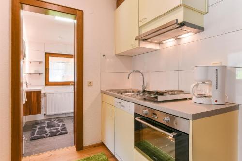 a kitchen with a sink and a counter top at Pension Seeberger in Wald am Arlberg