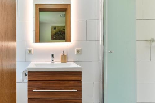 a bathroom with a sink and a mirror at Pension Seeberger in Wald am Arlberg