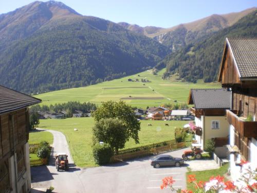 a village in a valley with mountains in the background at Hoazhof in Kals am Großglockner