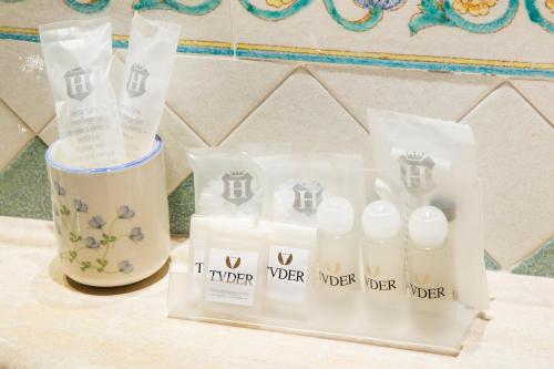 a group of three bottles of water and a cup at Hotel Tuder in Todi
