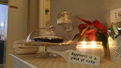 a cake on a plate on a counter next to a candle at La Terrazza sul Naviglio B&B in Bernate Ticino