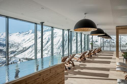 a room with a view of a snowy mountain at SKI - GOLF - WELLNESS Hotel Riml in Hochgurgl