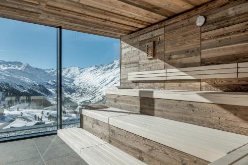 a room with a view of a snowy mountain at SKI - GOLF - WELLNESS Hotel Riml in Hochgurgl
