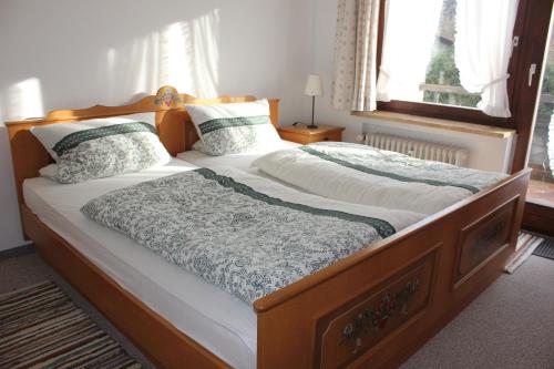 a bedroom with a large bed with two pillows at Fewo Königsberger in Garmisch-Partenkirchen