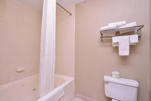 a bathroom with a tub and a toilet and a shower at Baymont by Wyndham Sioux Falls North,I-29,Russell St, Airport in Sioux Falls