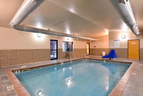 a large swimming pool in a building at Baymont by Wyndham Sioux Falls North,I-29,Russell St, Airport in Sioux Falls