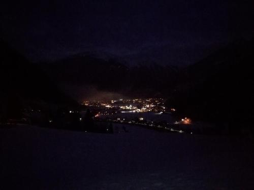 a view of a city at night in the snow at Haus Mühlbichl in Finkenberg
