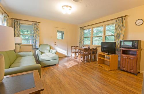 uma sala de estar com um sofá e uma televisão em Rough River Dam State Resort Park em Fentress McMahan