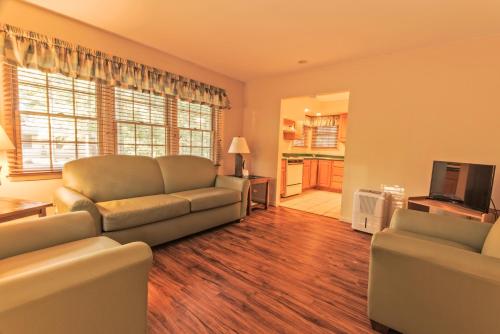 a living room with a couch and a television at Rough River Dam State Resort Park in Fentress McMahan