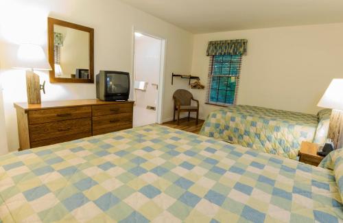 a hotel room with two beds and a television at Rough River Dam State Resort Park in Fentress McMahan